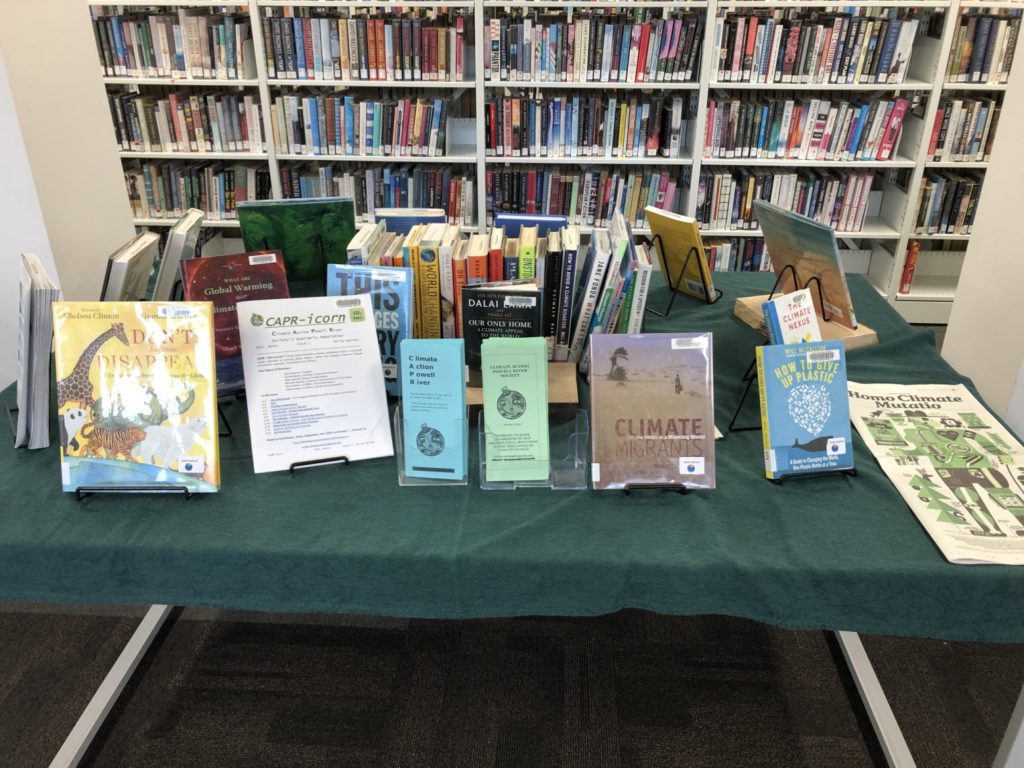 Table at Powell River Public Library displaying climate related books and resources